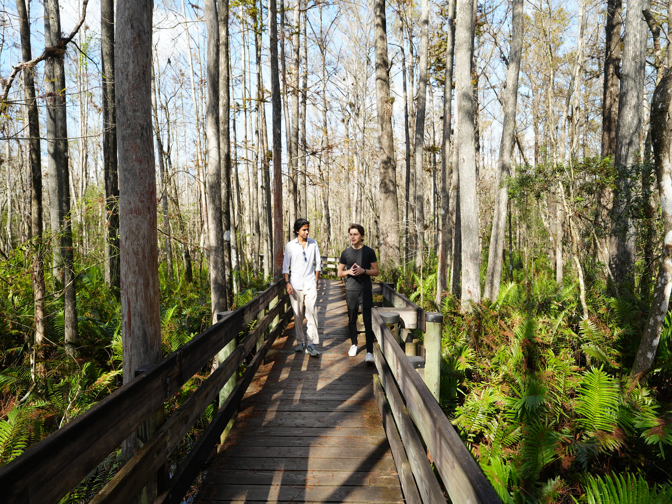 Priyam Raj walking with his cofounder on a trail in Fort Myers, Florida