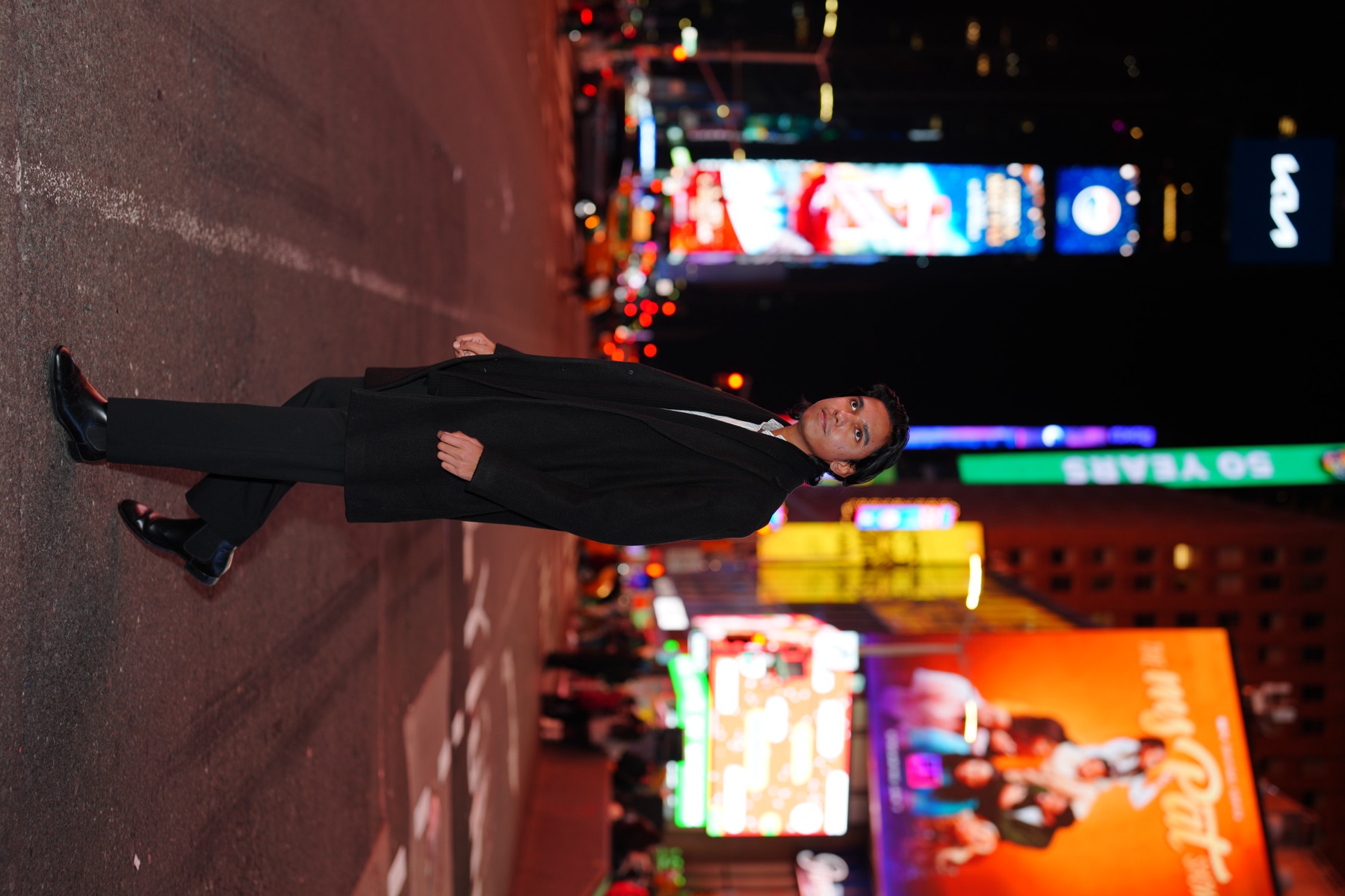 Priyam Raj walking through Times Square at night