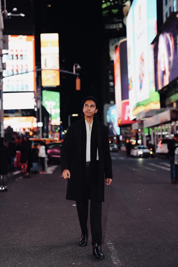 Priyam walking through Times Square at night